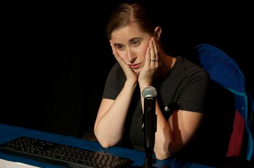 photo of woman sitting in front of keyboard and microphone